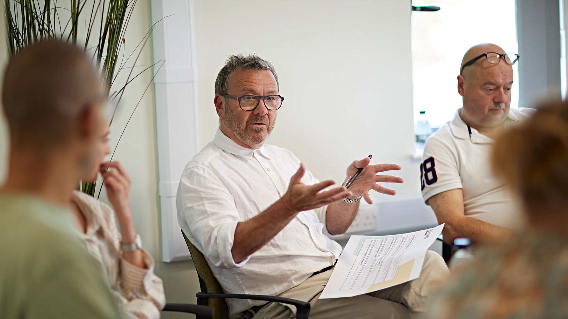 Men having a discussion around a table