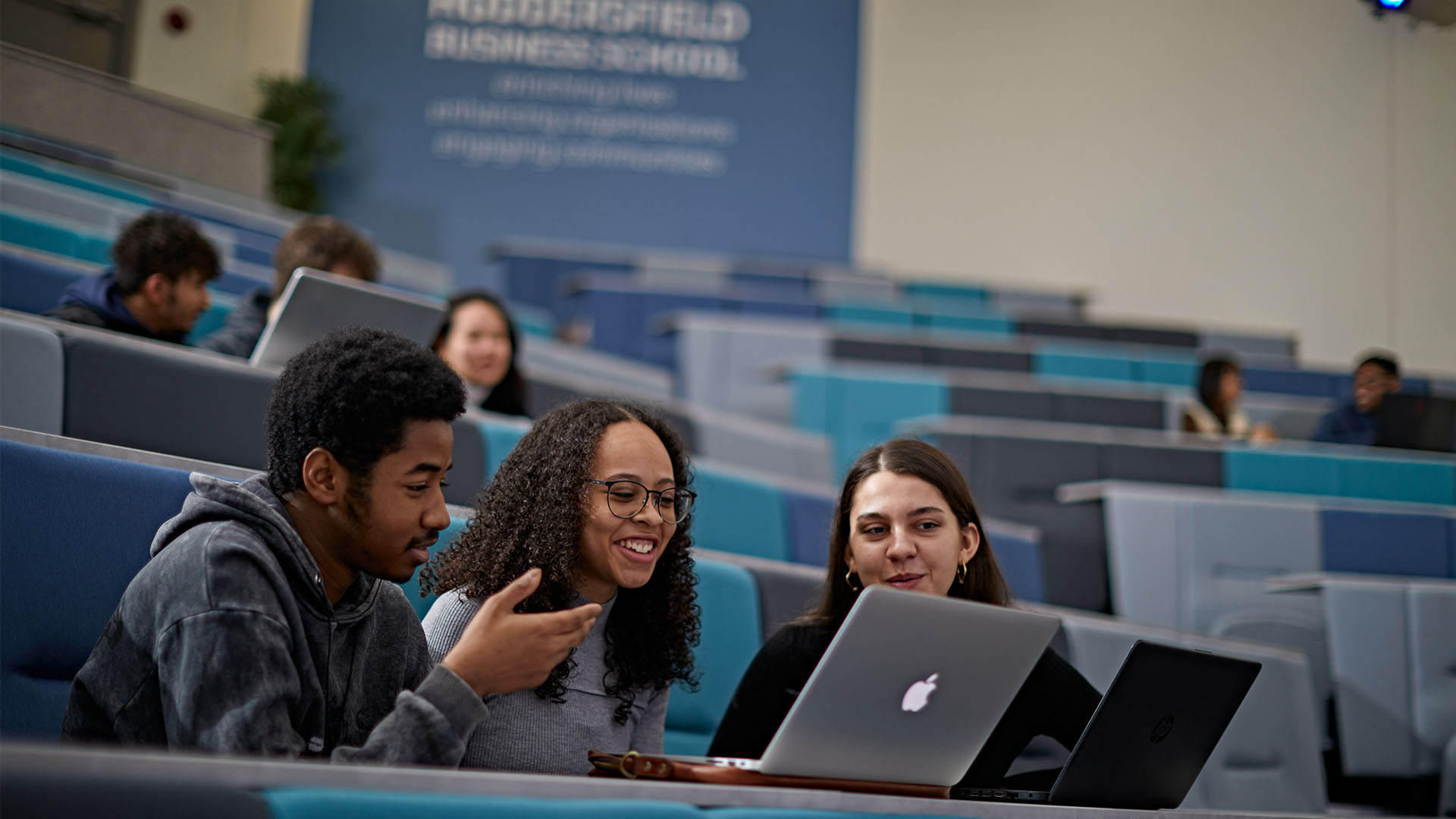 Three students in a lecture