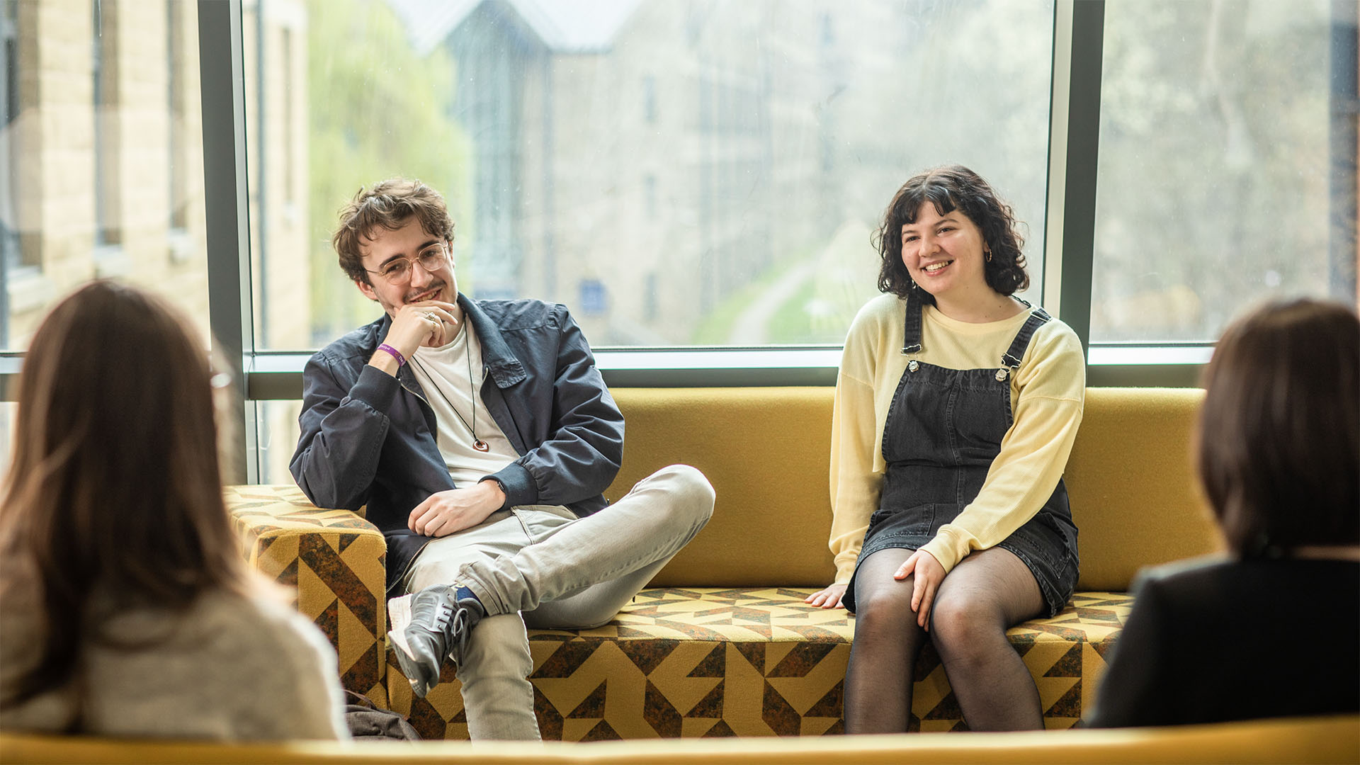 Students sat on couches in a breakout space
