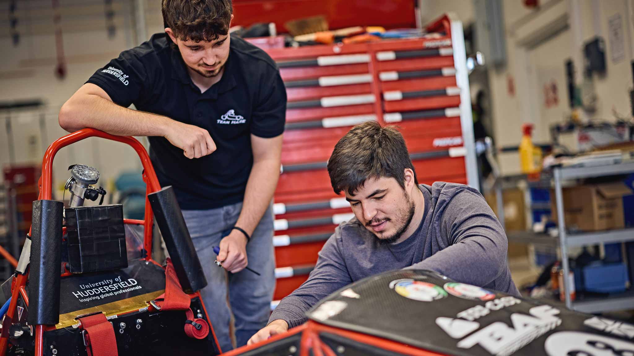 Automotive students working on a car
