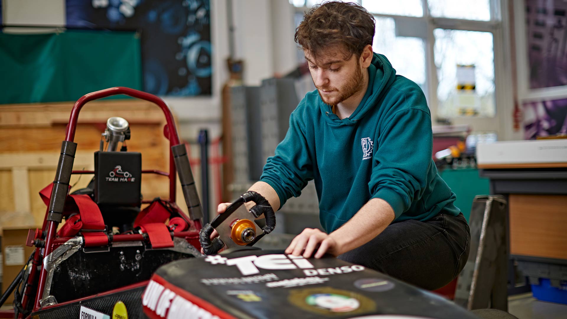 student working on car