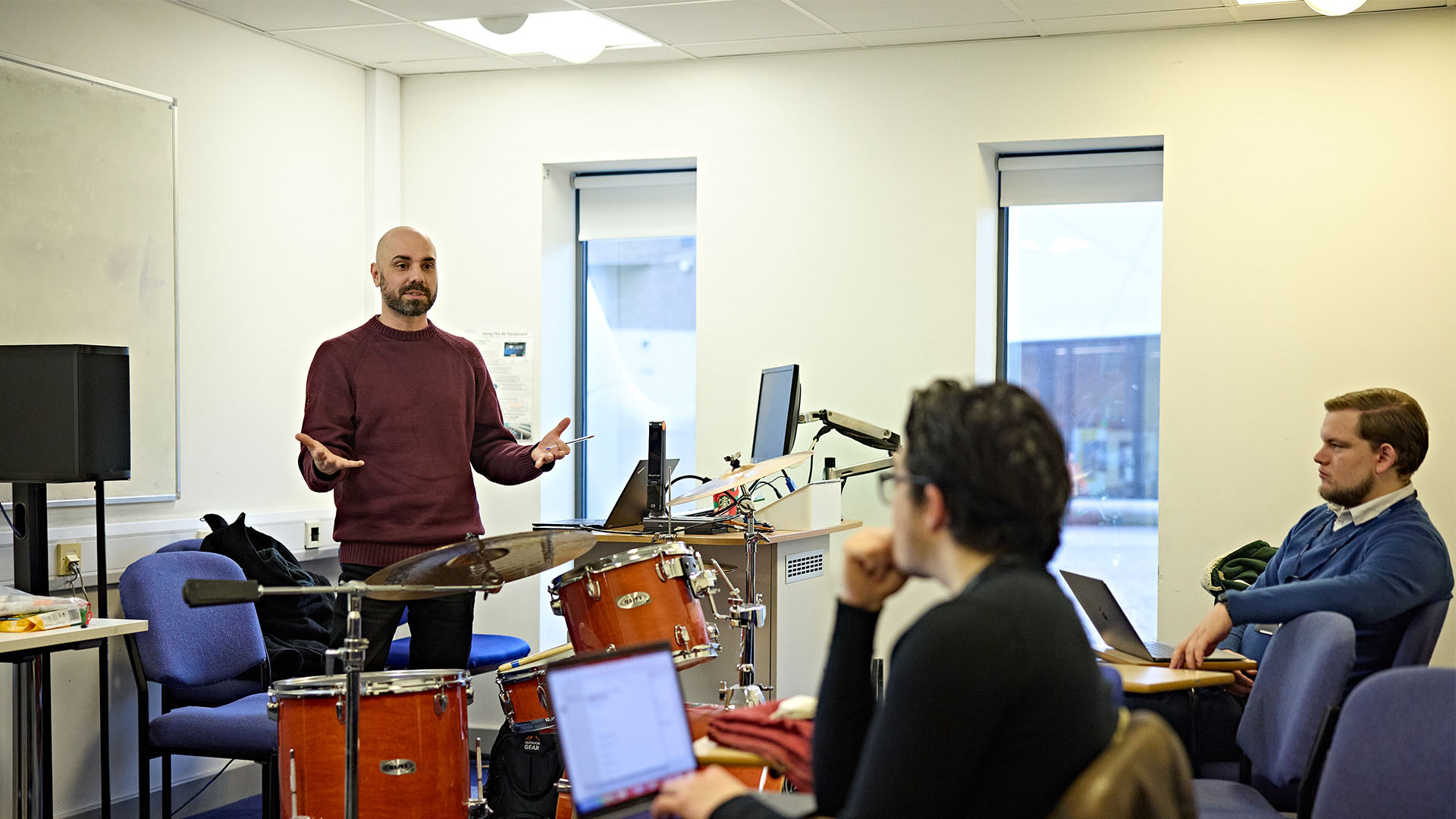 Music teacher speaking to students