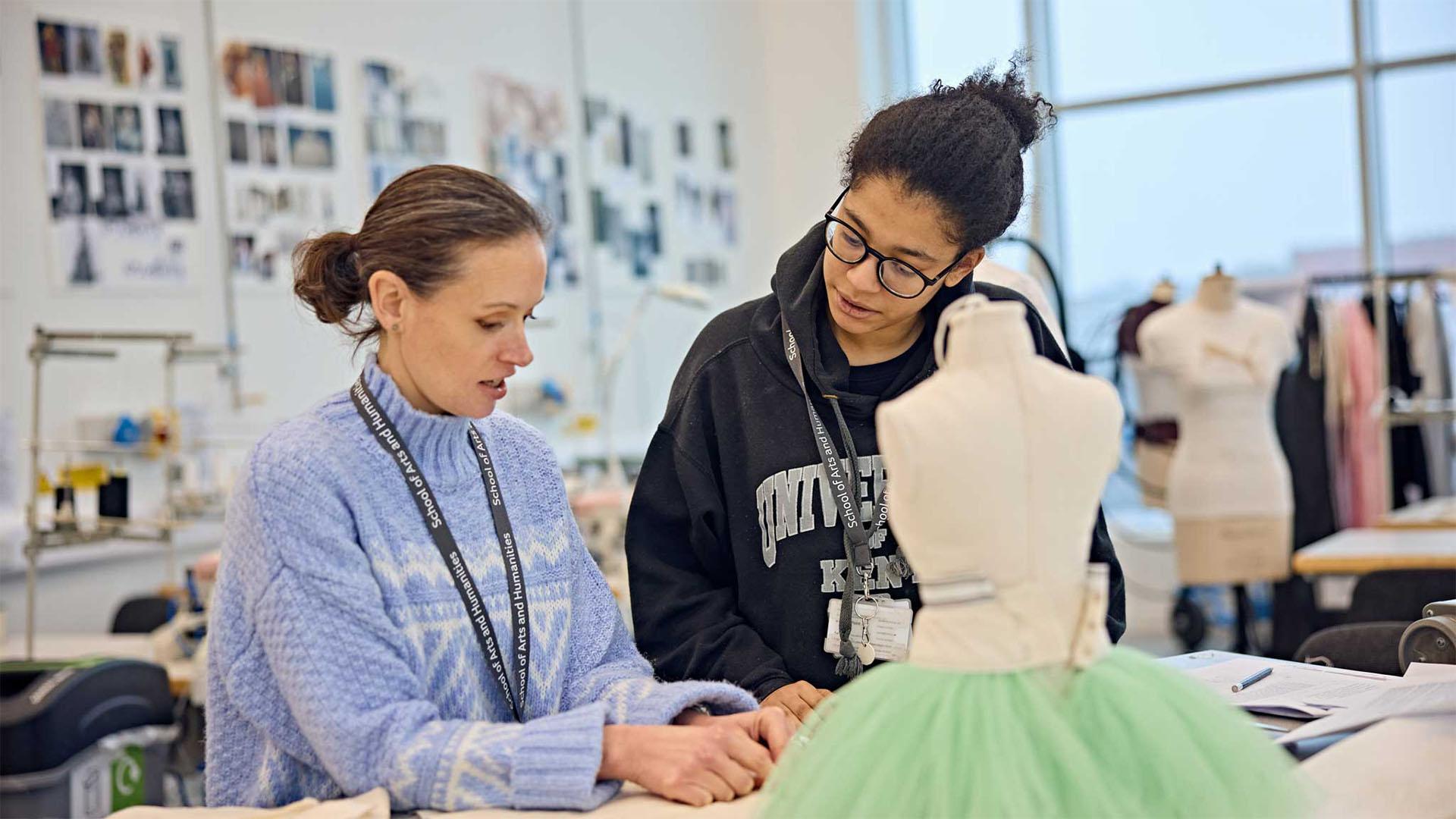 Teacher showing student how to use sewing facilities