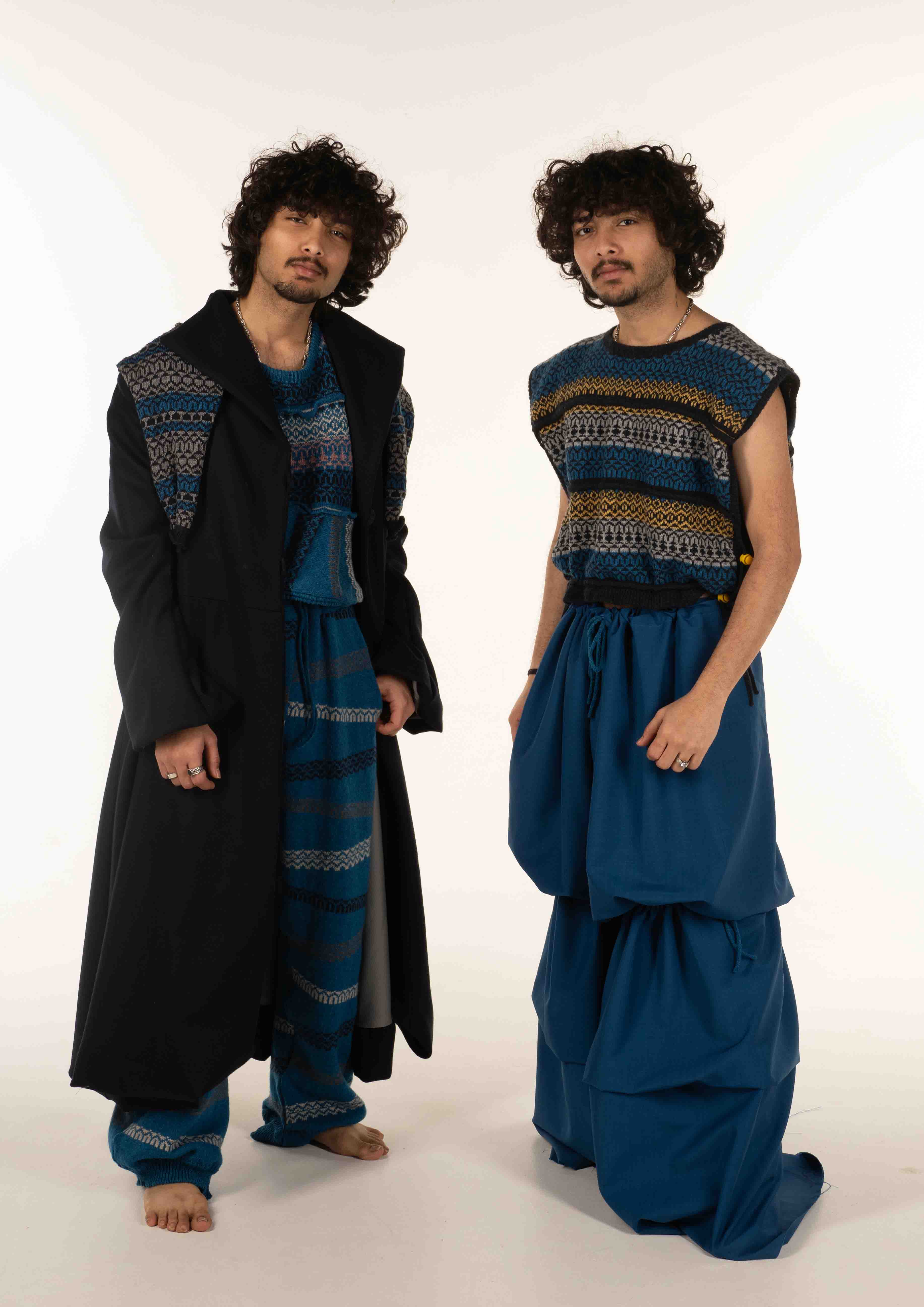 Photograph of two men posing in stylish outfits