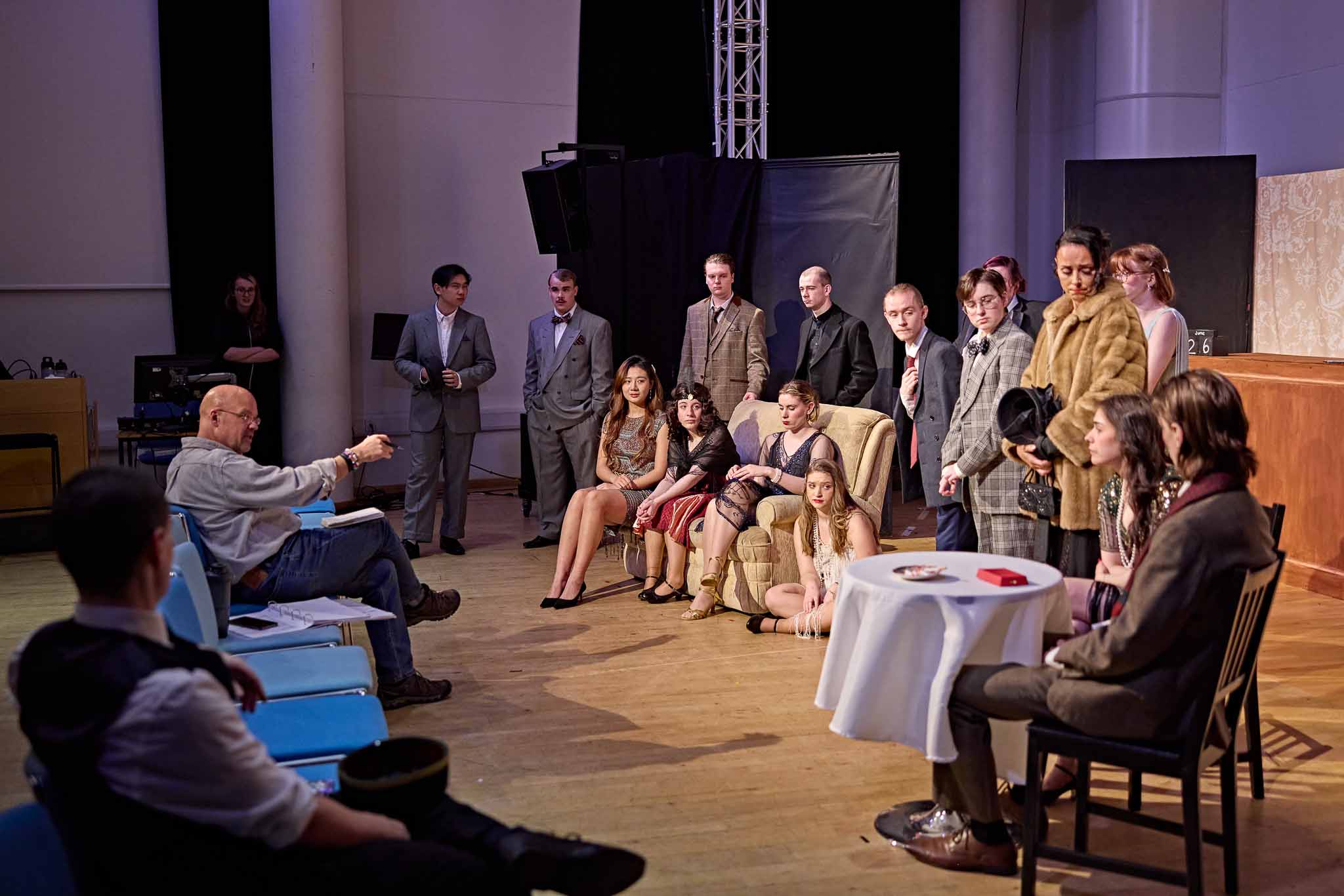 Lots of drama students on stage listening to their teacher