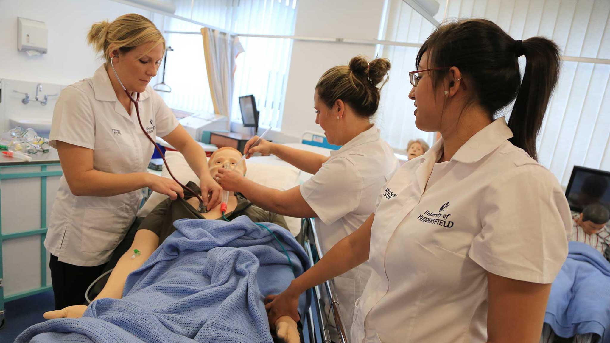 Students practising their skills on Sim Man